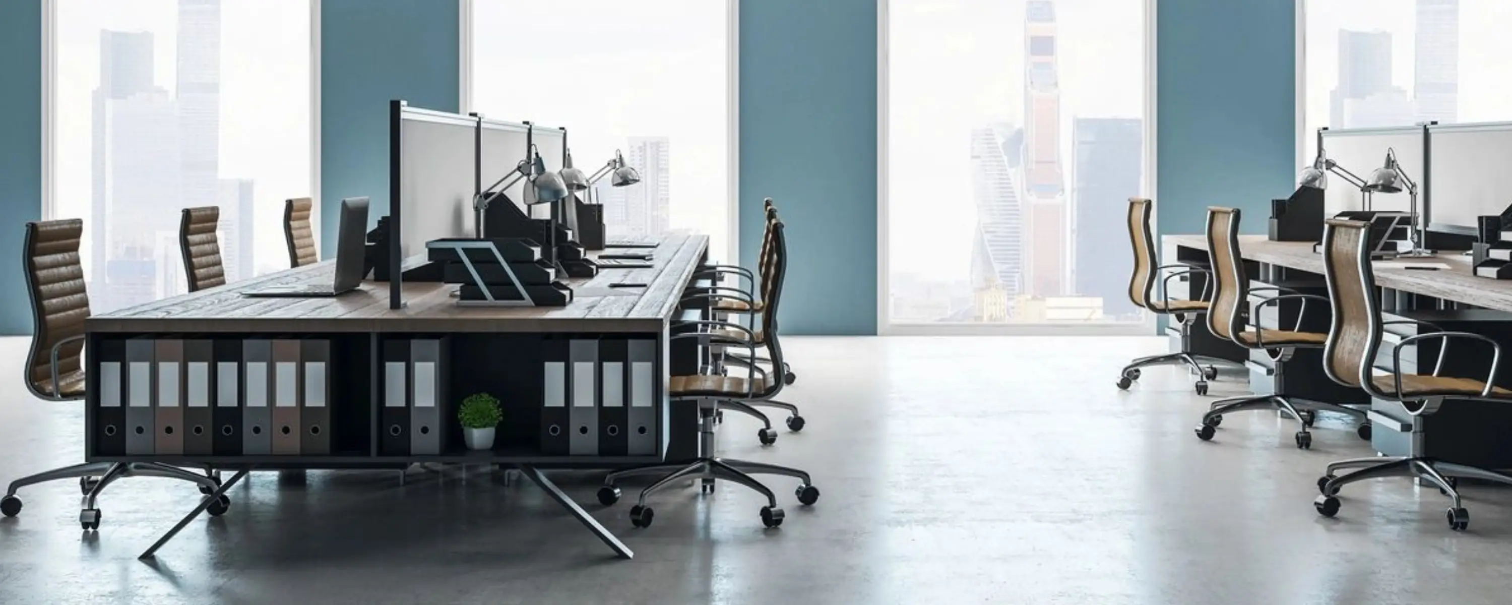 Modern office workspace with chairs and desks by a large window.